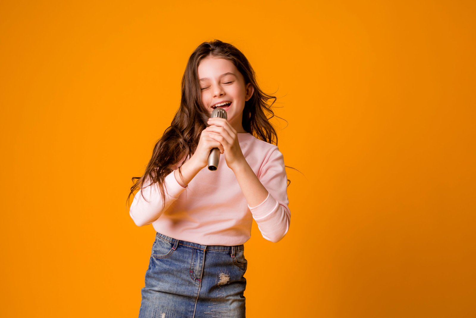 baby-girl-with-microphone-smiling-singing